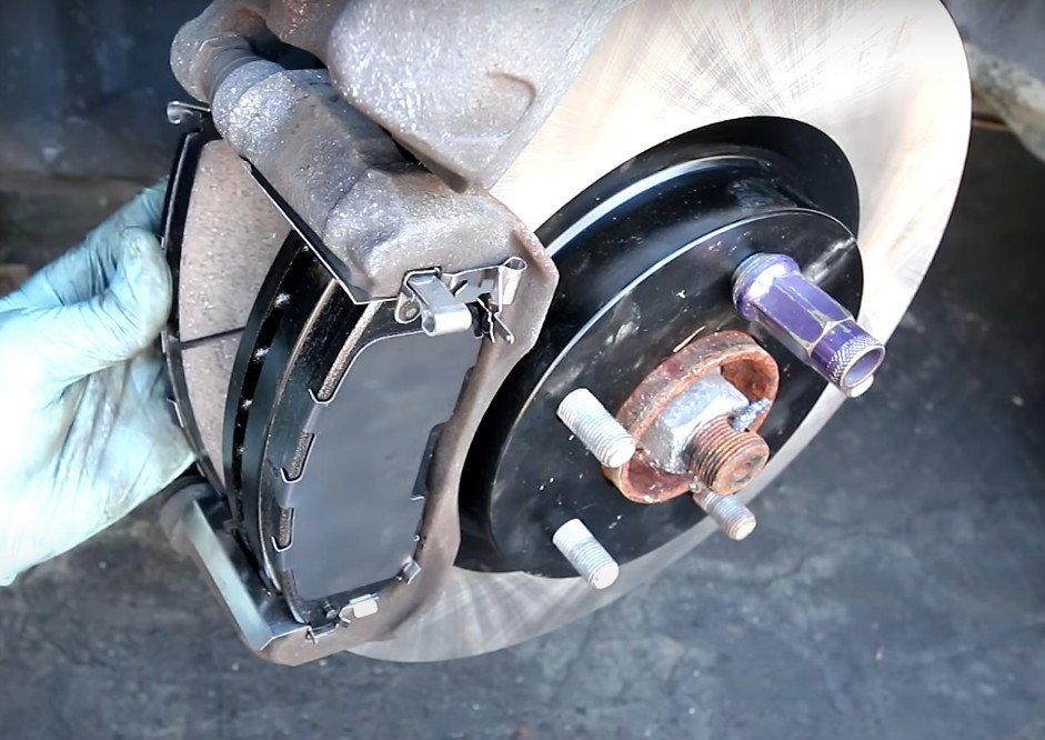 Anaheim Mobile Mechanic installing new disc brake pads for Anaheim, CA, motorist.