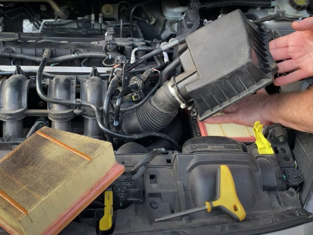 Automotive air filter replacement during routine servicing by Anaheim Mobile Mechanic.