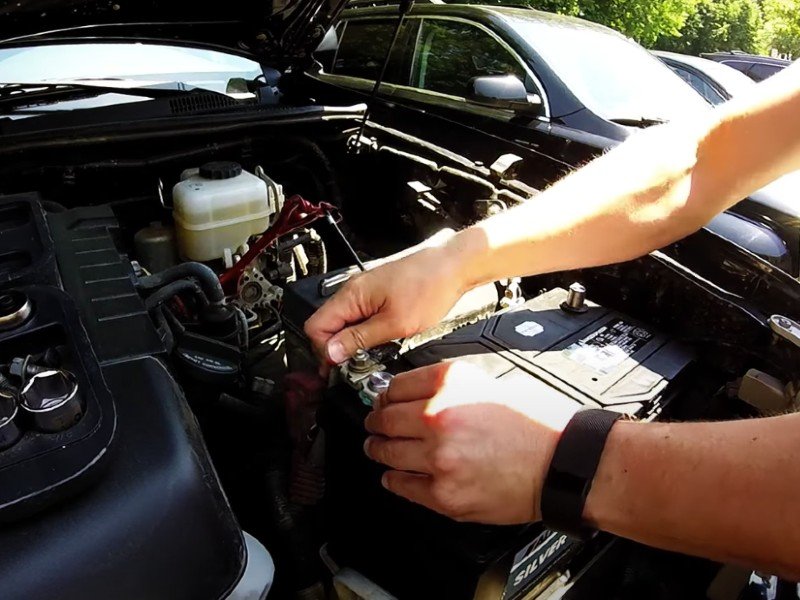 Mobile auto repair mechanic changing truck battery in Anaheim