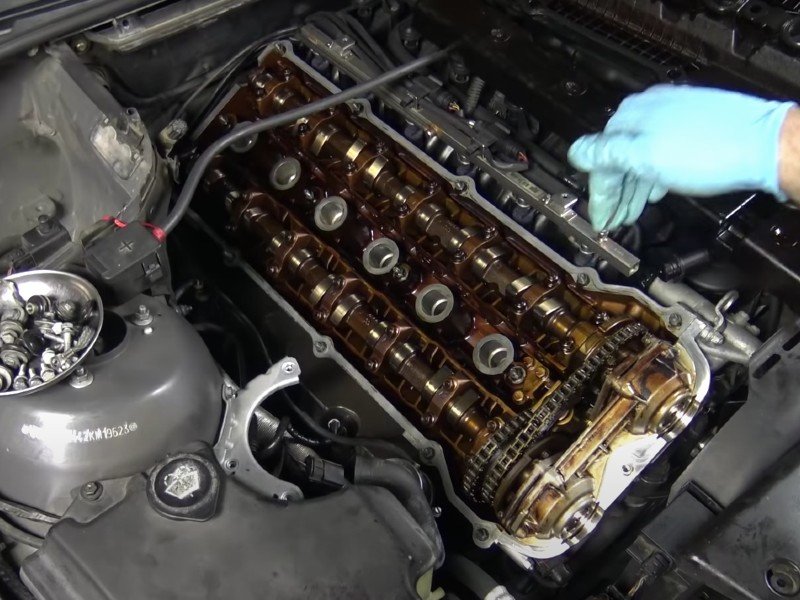 A vehicle engine's valve cover gasket being replaced by a mobile auto repair mechanic in Anaheim.